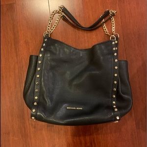 Michael Kors black leather bag with gold accents.